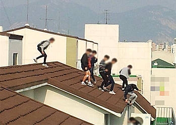 옥상에서 담배를 피우다 경찰을 피해 달아가는 청소년들/뉴시스