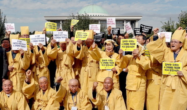 재경제주4·3희생자및피해자유족회 관계자가 18일 오전 서울 영등포구 국회 정문에서 상복을 차려 입고 제주4·3사건진상규명및특별법 개정을 촉구하는 구호를 외치고 있다.