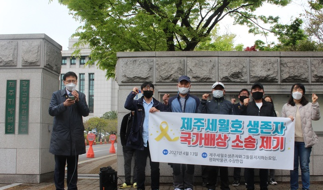 '세월호' 참사 생존자들이 13일 오전 제주지방법원 정문 앞에서 기자회견을 열고 국가 배상을 요구하는 구호를 외치고 있다.