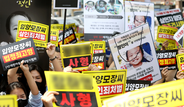  '정인이' 양부모의 1심 선고 공판이 열린 14일 오후 서울 양천구 서울남부지방법원 입구에서 시민들이 양모가 탑승한 것으로 보이는 호송차를 향해 손피켓을 들고 항의하고 있다.