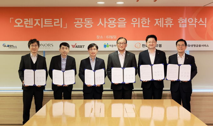 27일 여의도 63빌딩에서 글로벌금융판매, 아너스금융서비스, 더블유에셋, 피플라이프, 한화라이프랩과 ‘오렌지트리 공동사용을 위한 전략적 양해각서(MOU)’를 체결하고 기념촬영을 하고 있다. (왼쪽부터) 더블유에셋 조병수 대표이사, 아너스금융서비스 김만호 총괄이사, 글로벌금융판매 김종선 대표이사, 피플라이프 구도교 대표이사, 한화라이프랩 고병구 대표이사, 한화생명금융서비스 이경근 대표이사