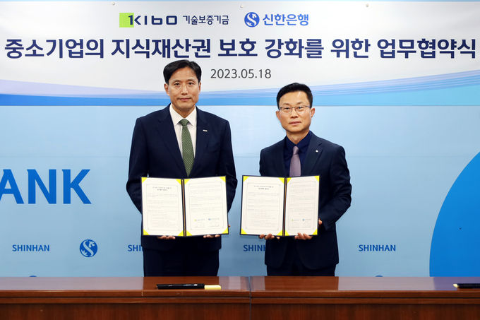 신한은행과 지식재산권 보호 및 기술금융 강화 추진 업무협약식 후 기념촬영하는 모습. 박주선 기술보증기금 이사(사진 왼쪽)와 김윤홍 신한은행 부행장(사진 오른쪽) ⓒ 파이낸셜데일리 / 기술보증기금